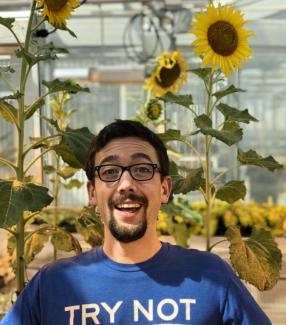 Dr. Daniel Jones of Auburn University smiles in front of a background of sunflowers