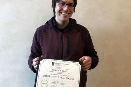 Bill Ricci posing with Paper of the Year Award